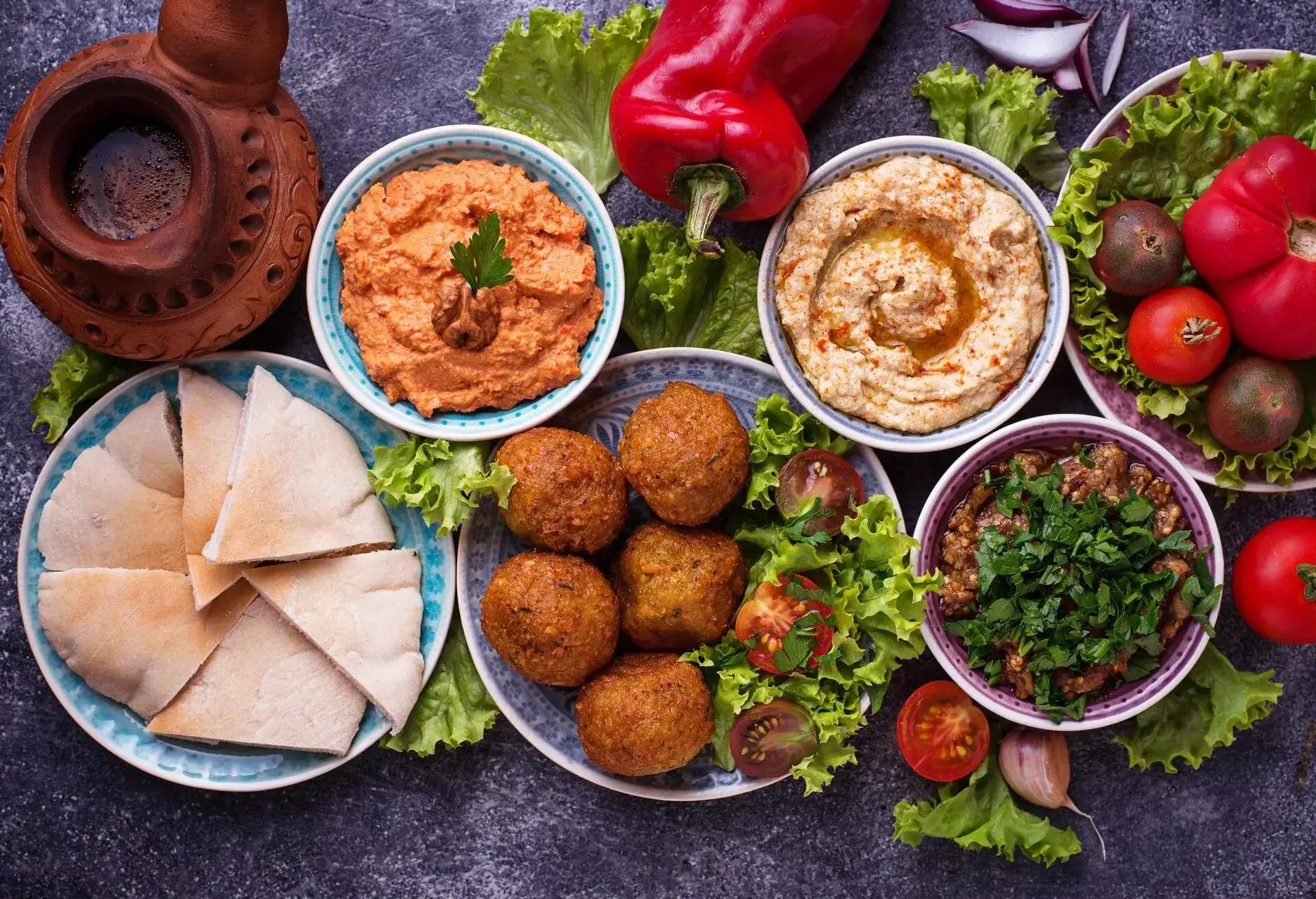 Selection of Middle eastern or Arabic dishes. Falafel, hummus, pita and muhammara. Top view