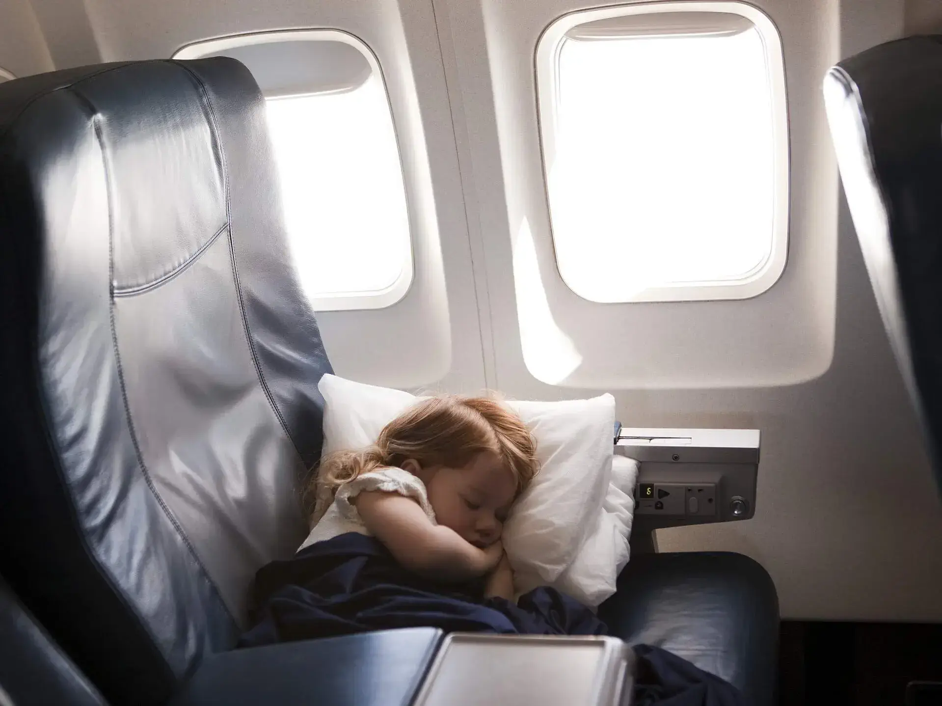 Kid girl sleeping on an airplane