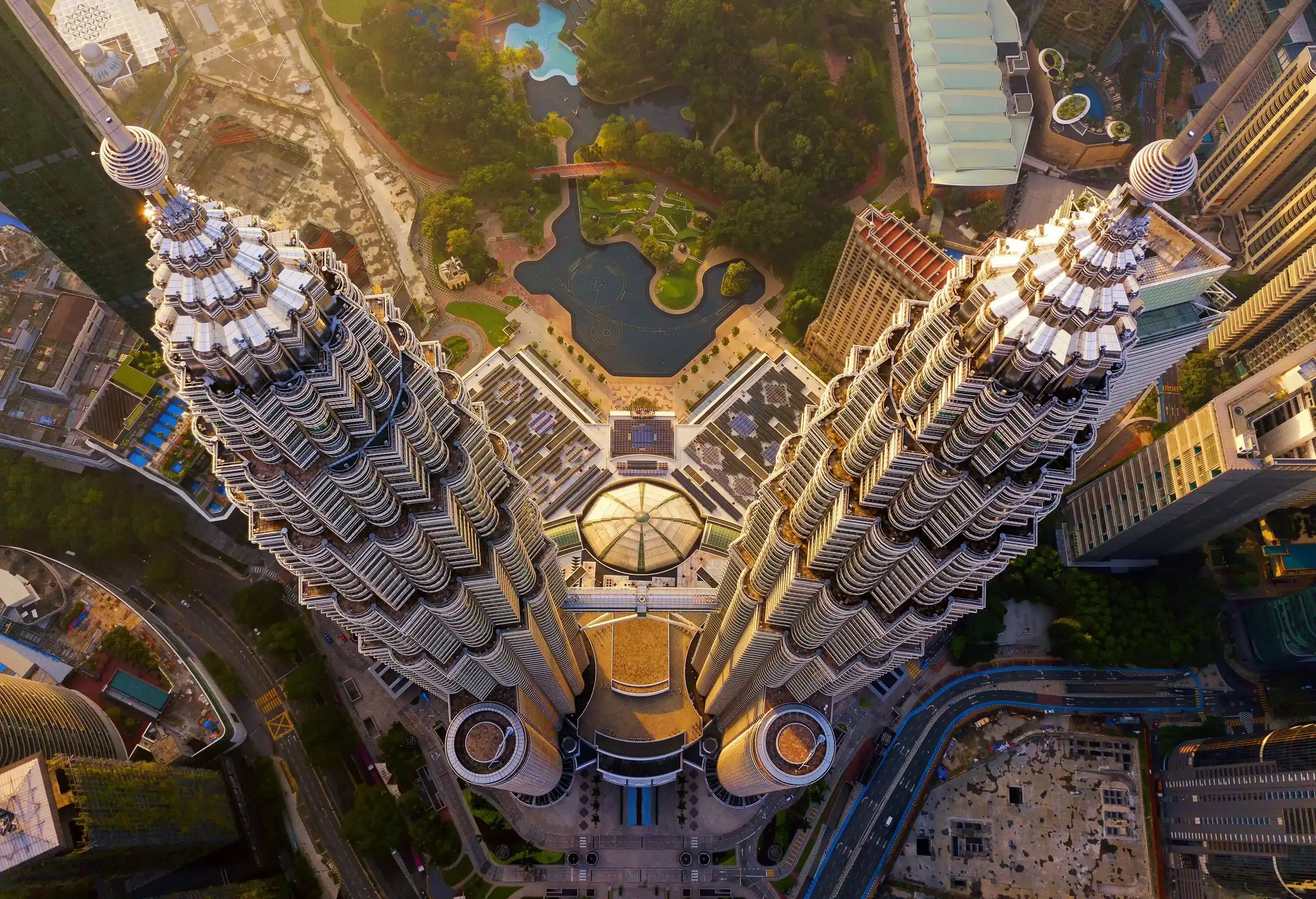 Drone view of skyscraper and high-rise buildings at sunset.