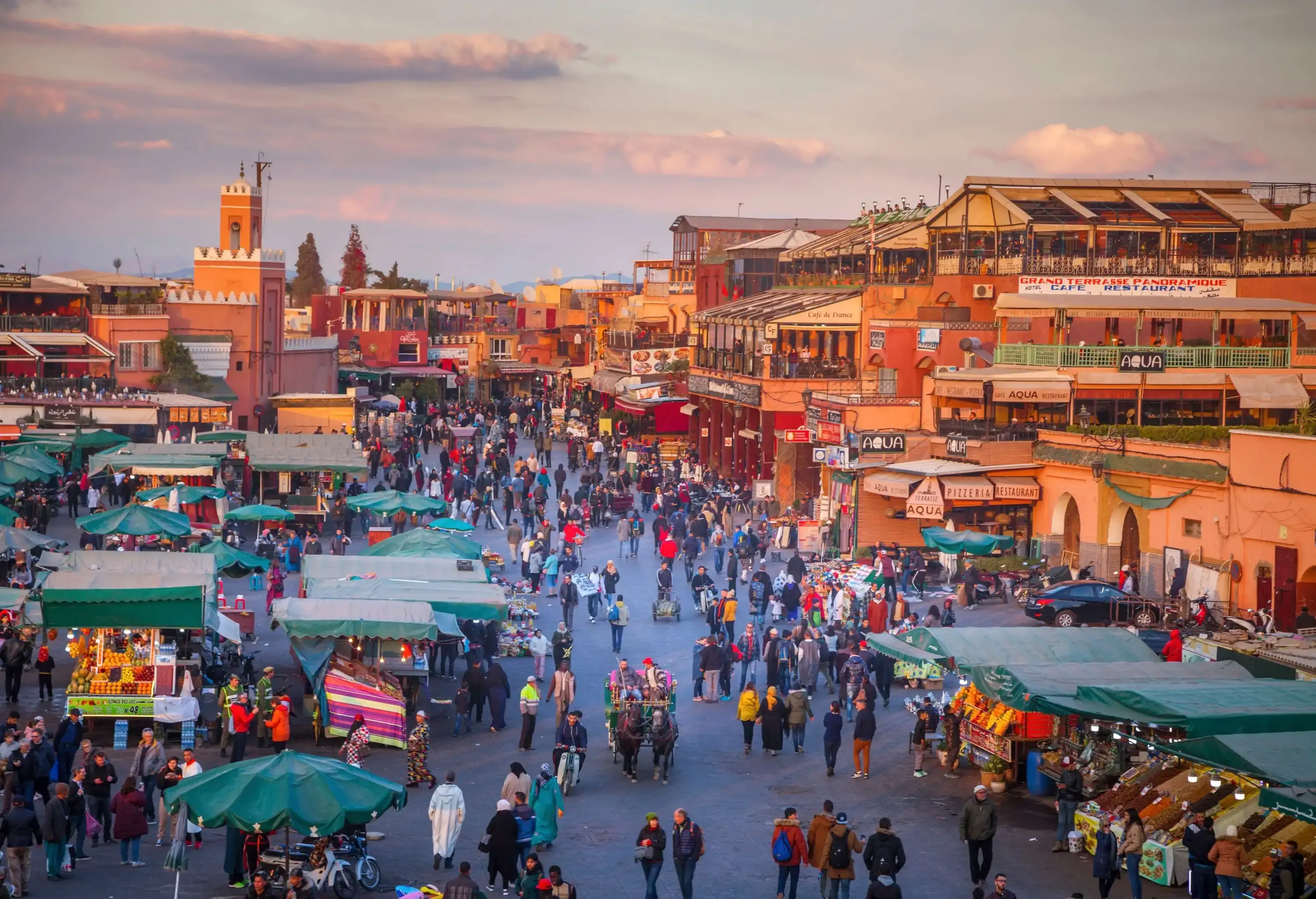 High angle view of busy colourful market square surrounded by red brick buildings
