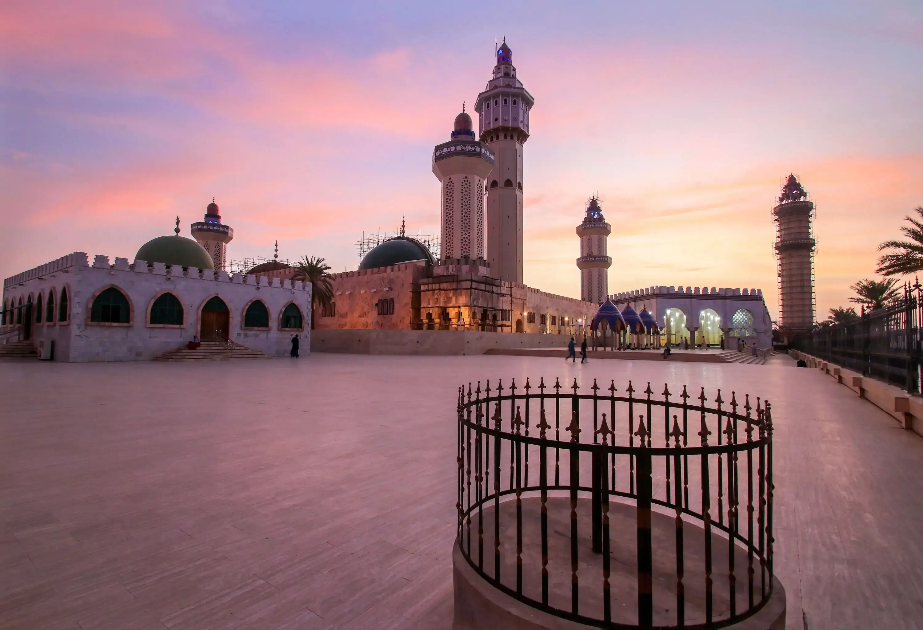 Picturesque Great Mosque of Touba with five towering minarets against the scenic twilight sky.
