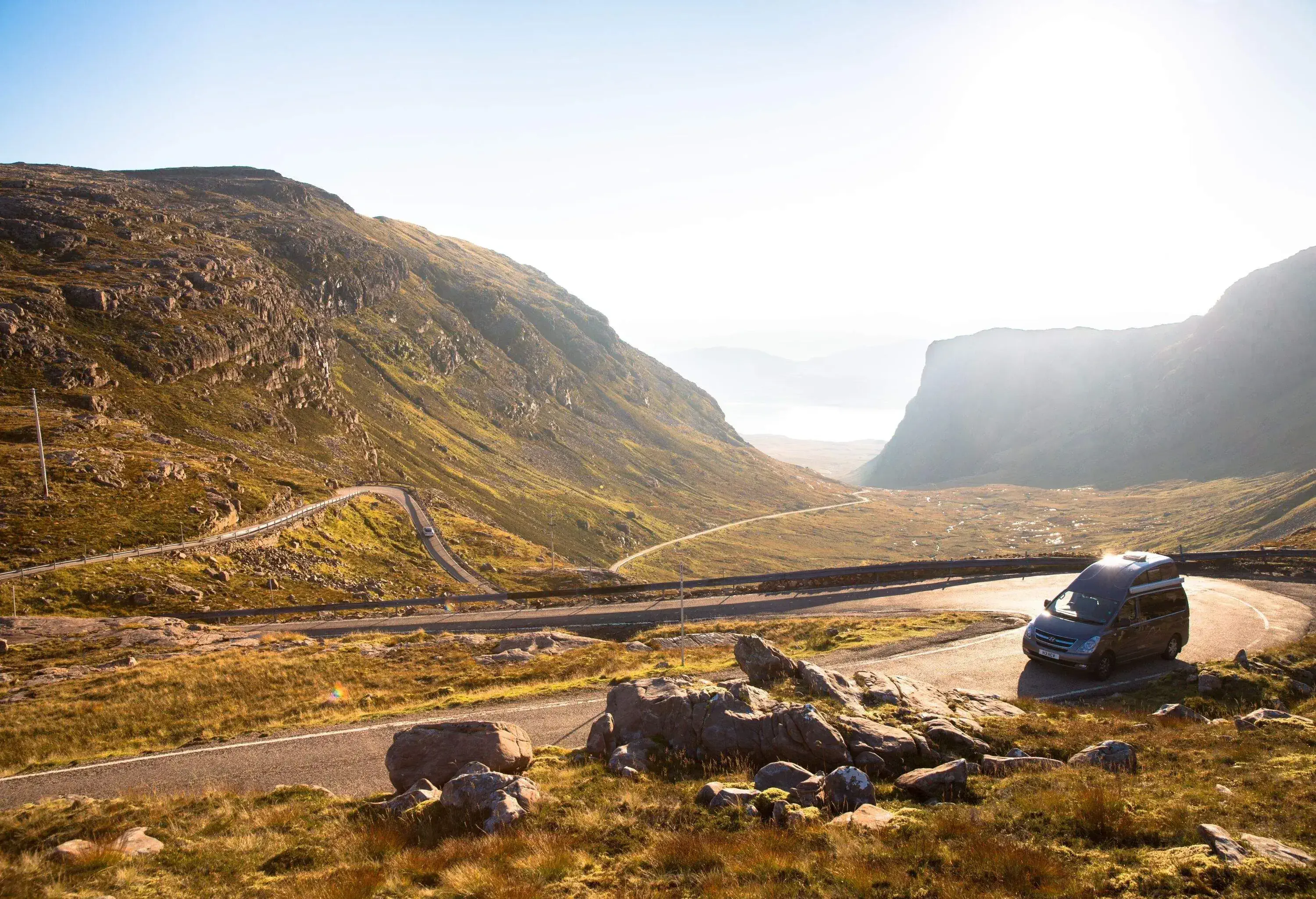 Campervan climbing Applecross pass, North West Scotland, UK