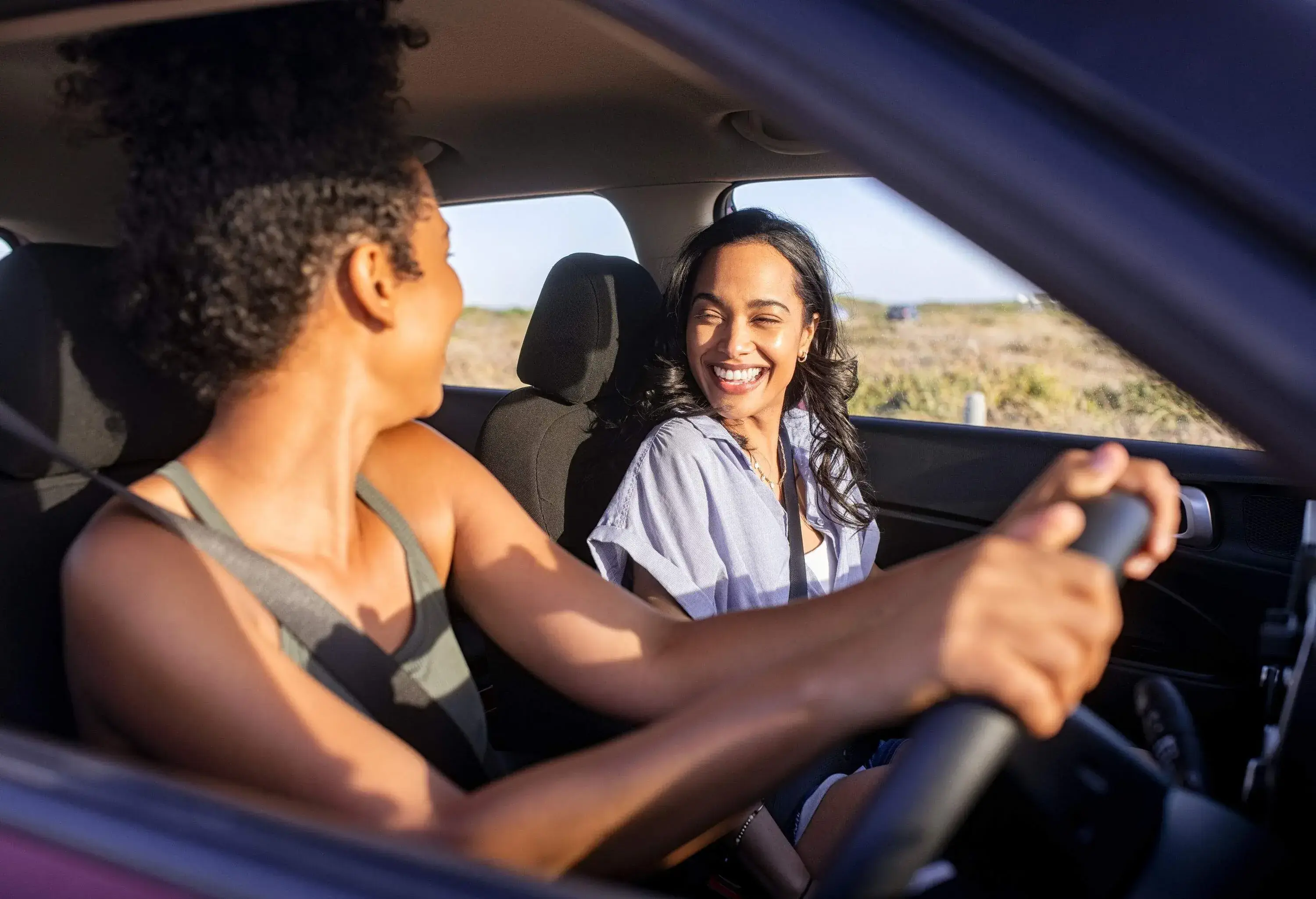 Two friends having fun during a car ride.