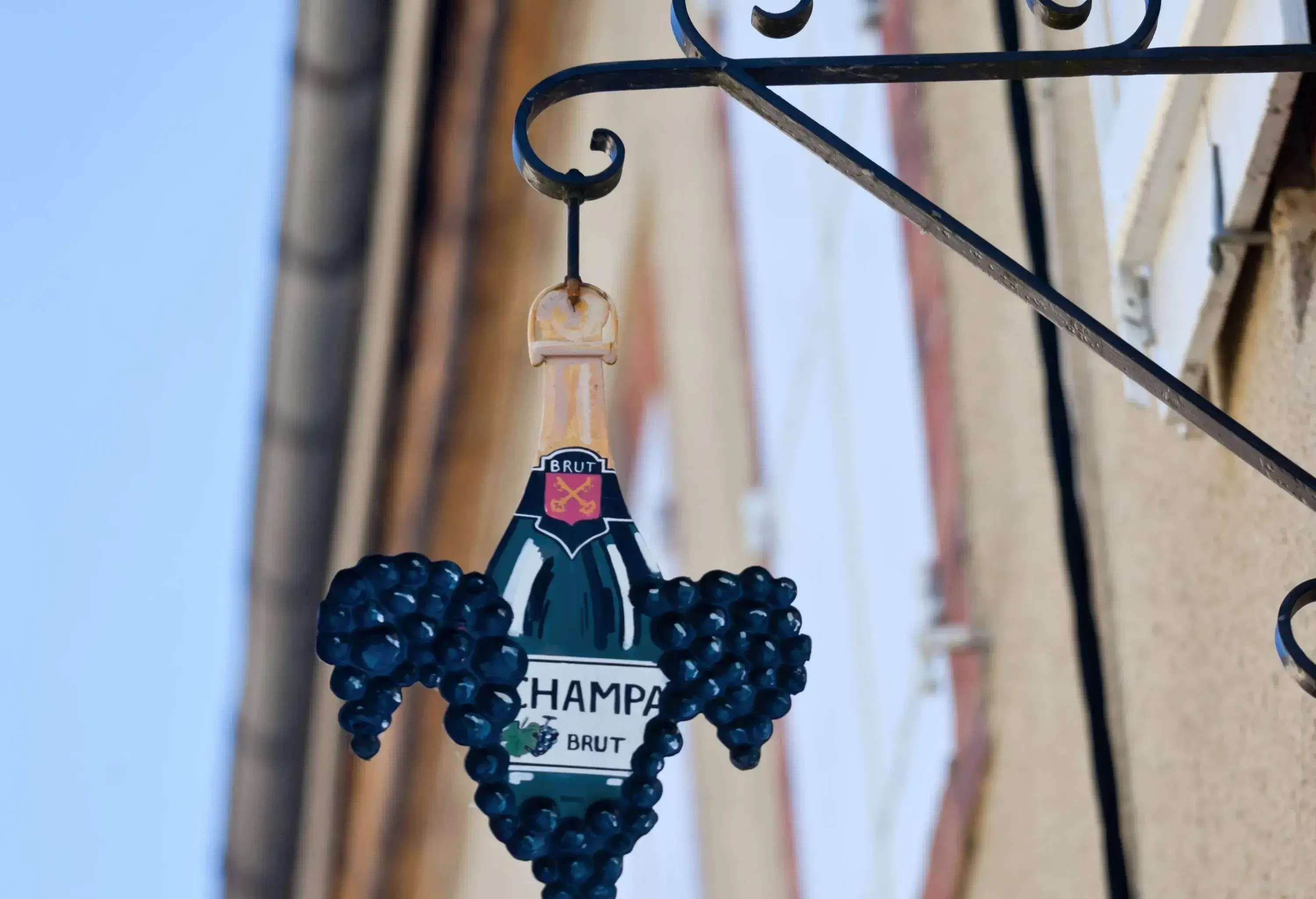 Hanging Metal Sign of Champagne Bottle with Hautvillers Village Crossed Key Crest and Pinot Noir Grapes