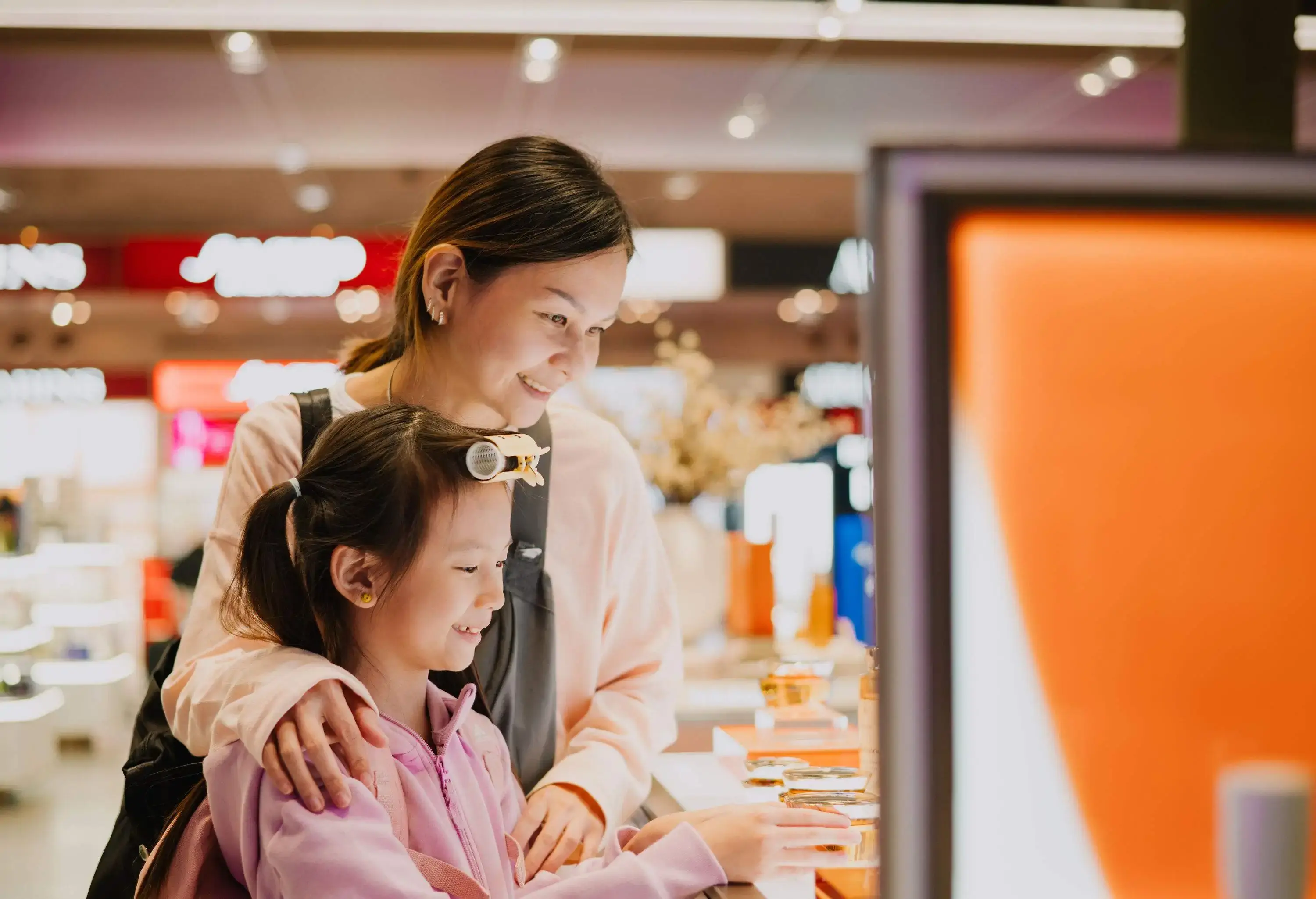 Asian Chinese Mother And Daughter Shopping at Airport Duty free