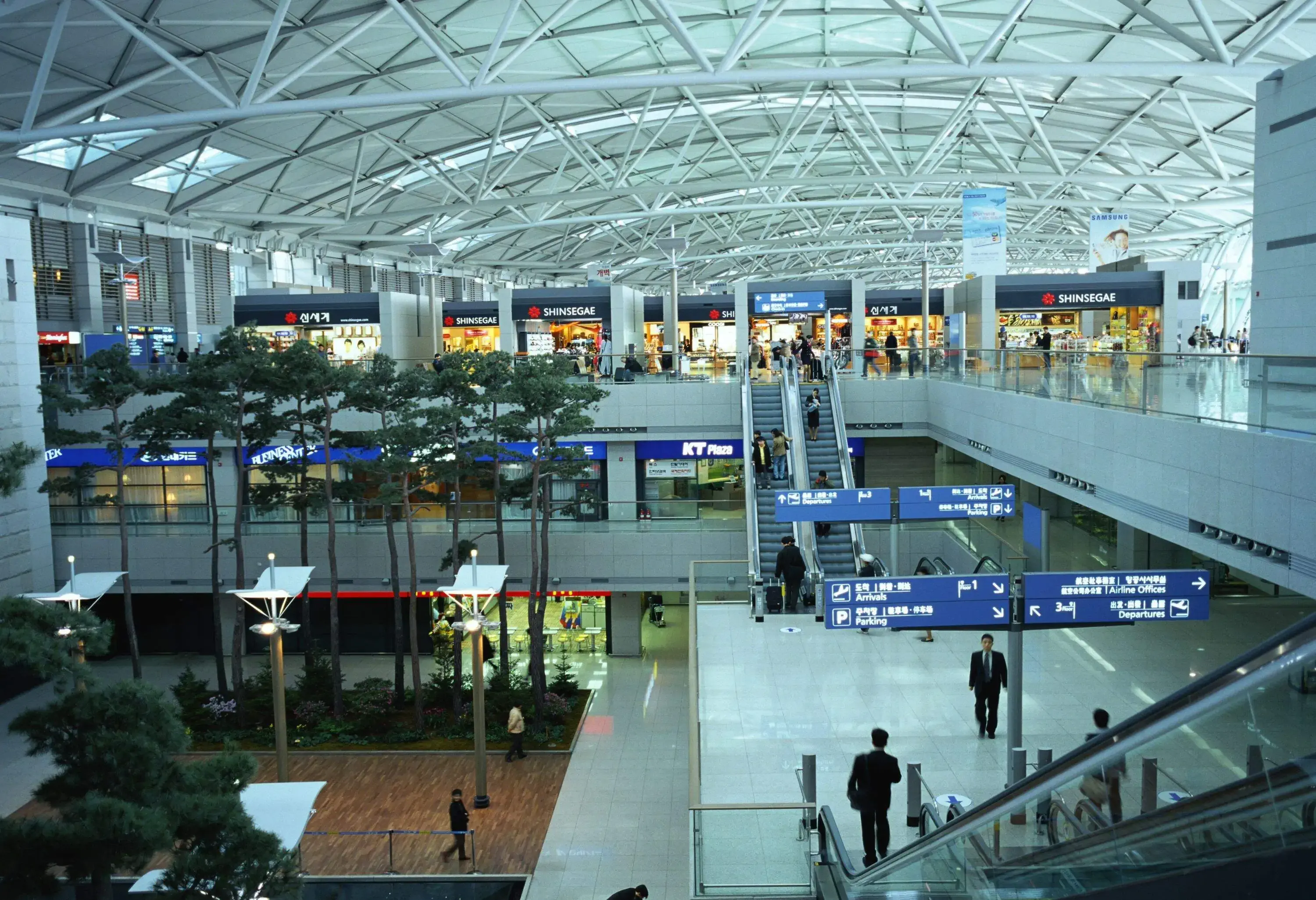 Interior shot of busy international airport with escalators going down main hall