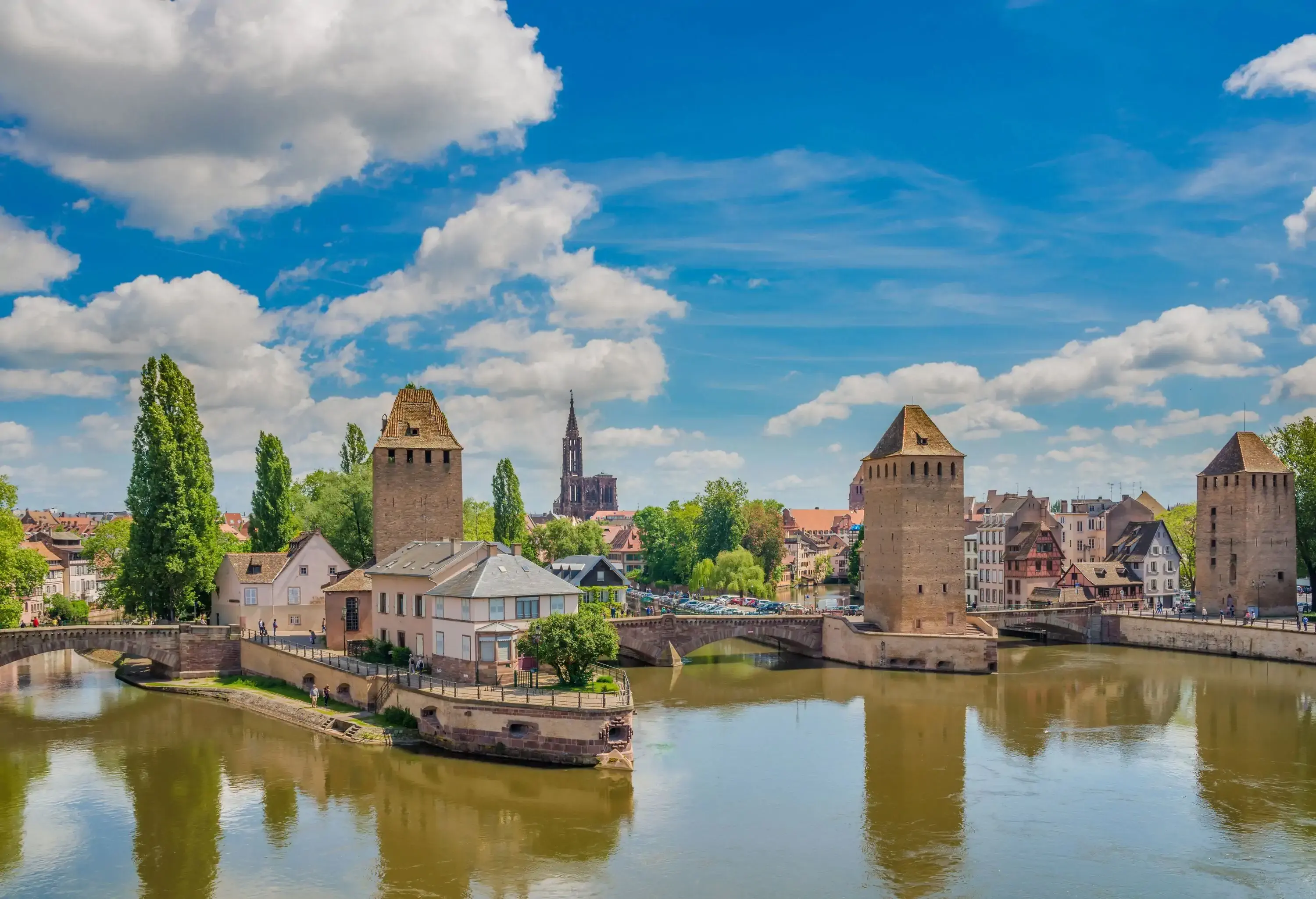 Panoramic view of an old European city with two bastions over a river canal on a sunny summer day