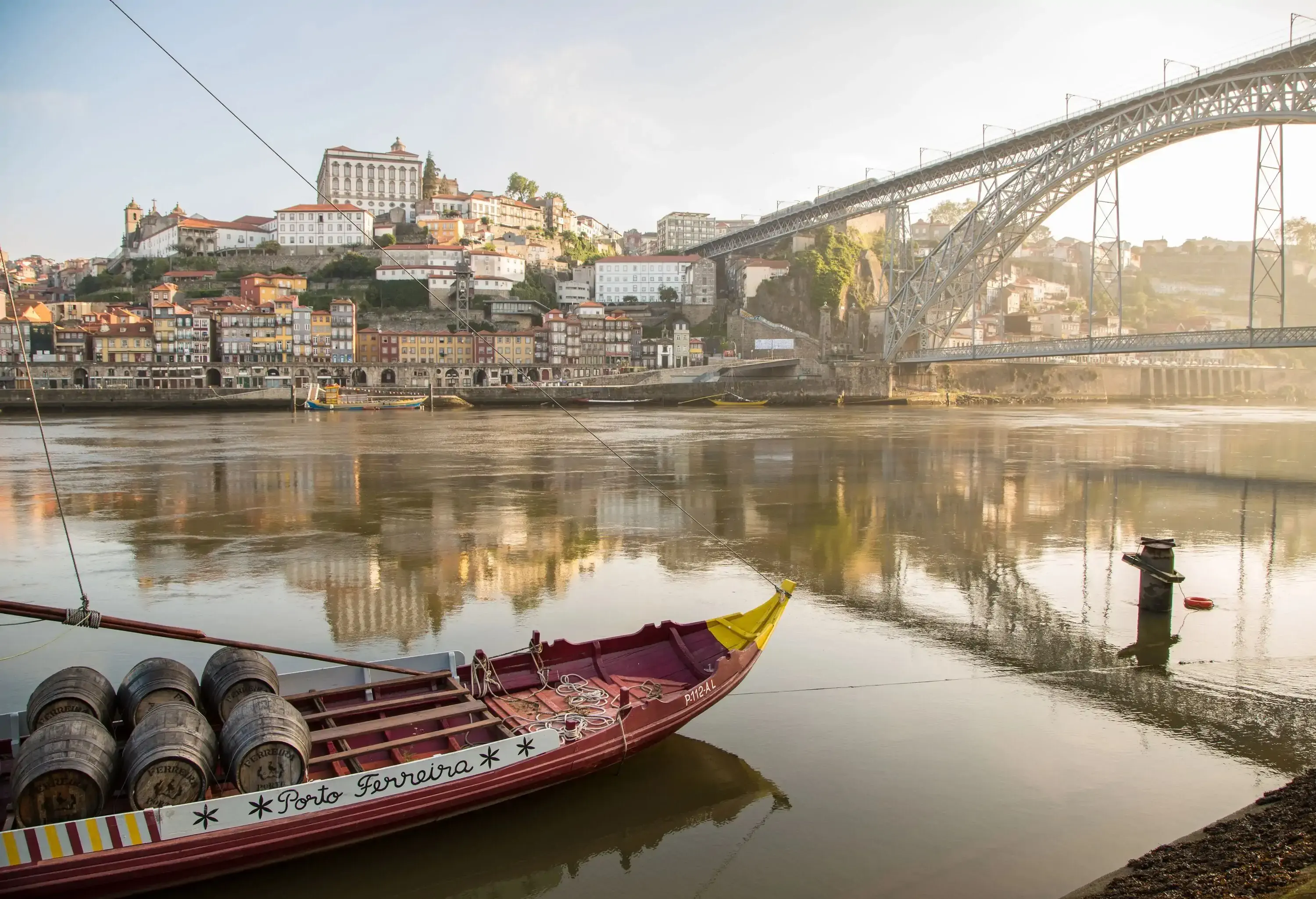 Historical Port Wine ship at river Douro with Ponte Luis I and Oporto cathedral in the background in Oporto, Portugal