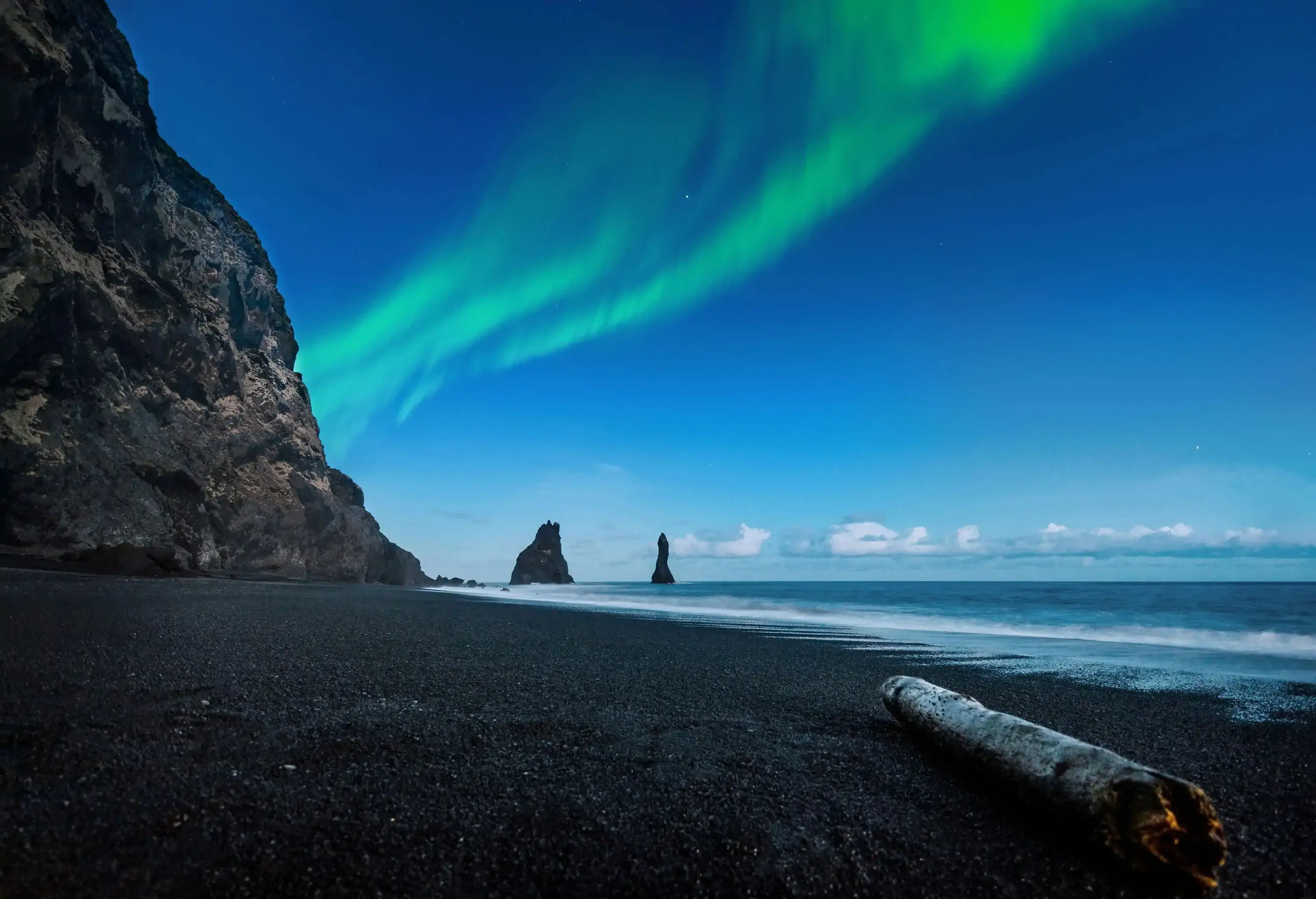 Northern lights above an icelandic beach in Vik at Iceland.