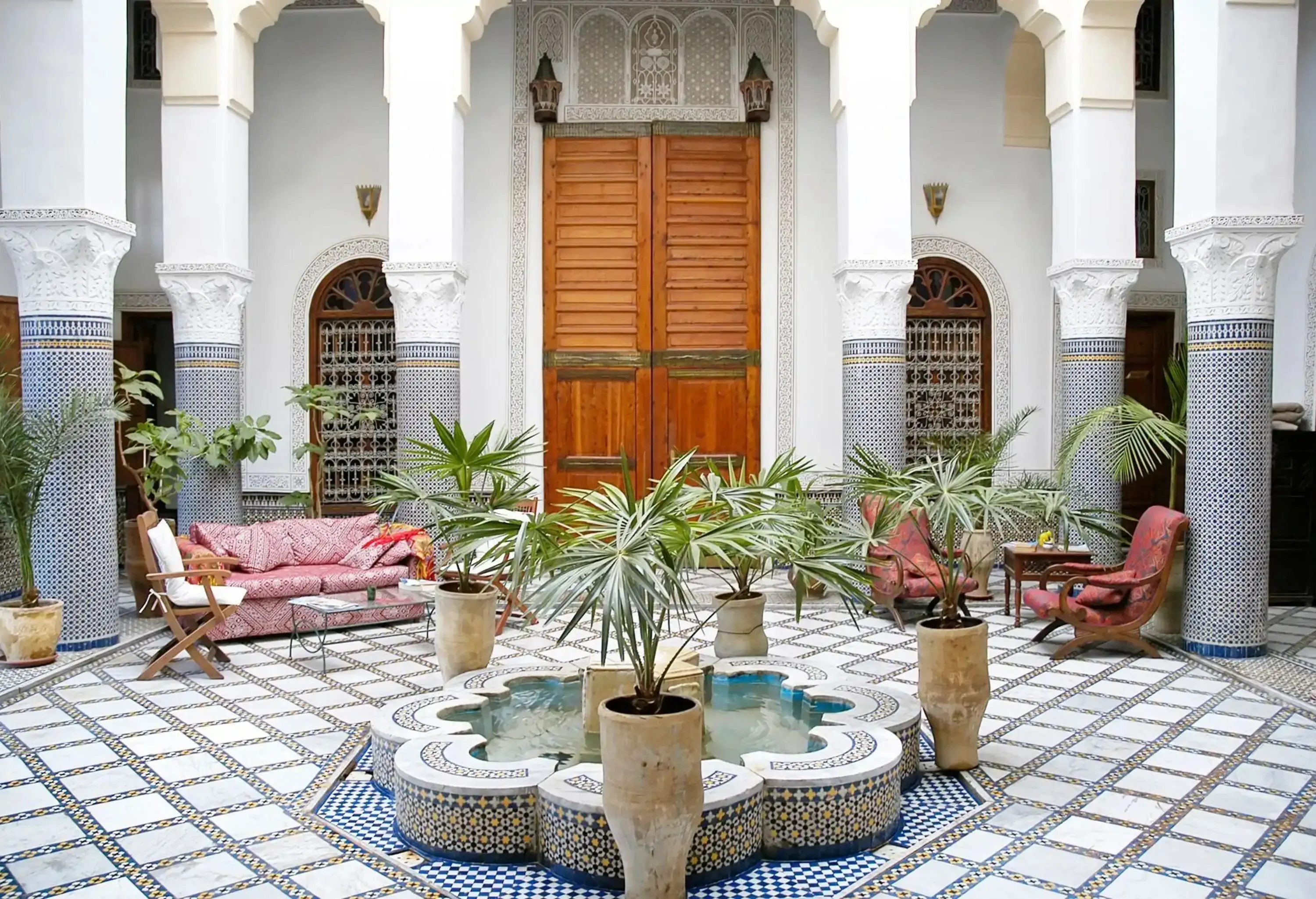 Courtyard in old riad (traditional Moroccan house or palace) in Fez, Morocco with fountain