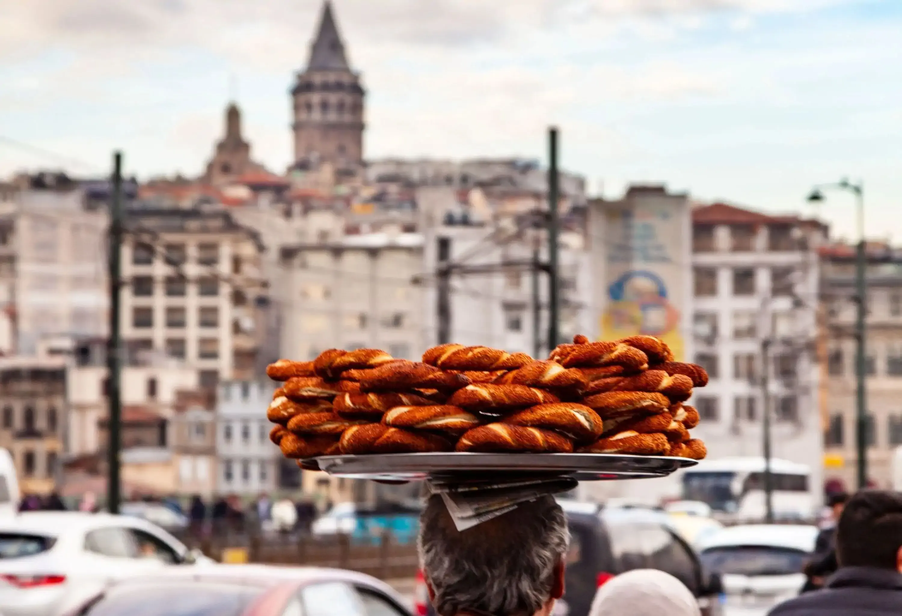 Man carrying sweets on his headin a busy city