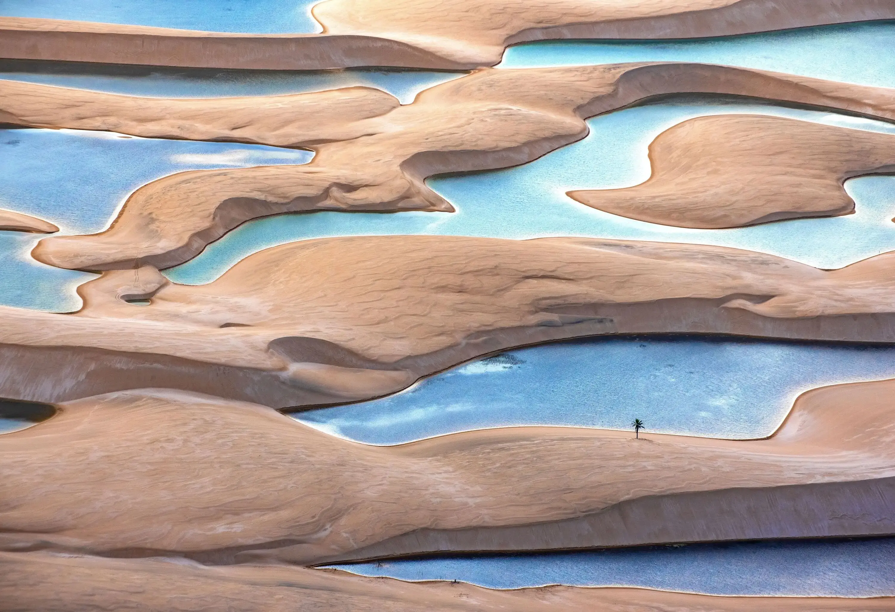 Drone view of sand dunes and pools of water