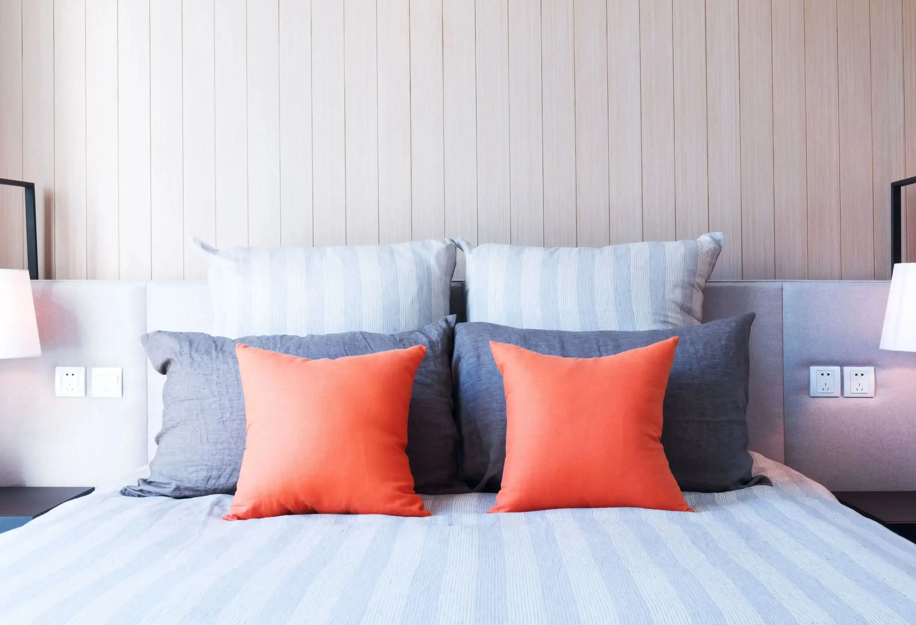 Pillows are arranged from smallest to biggest on the head part of the bed. 