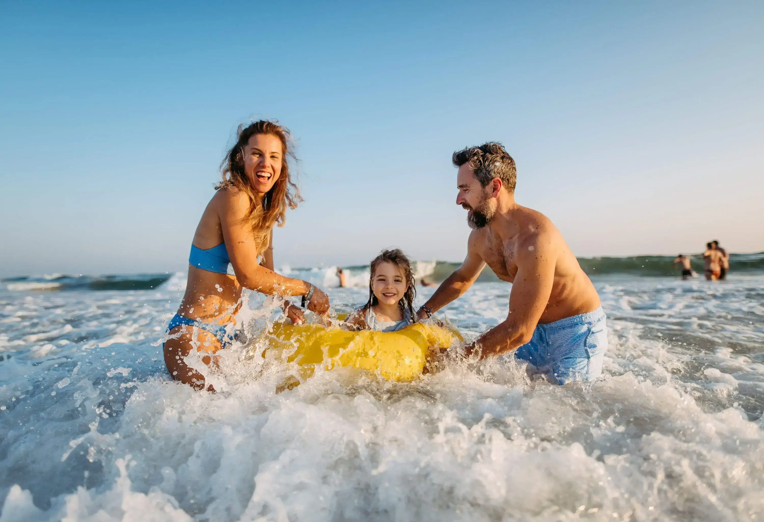 A family swimming in the ocean together and having fun