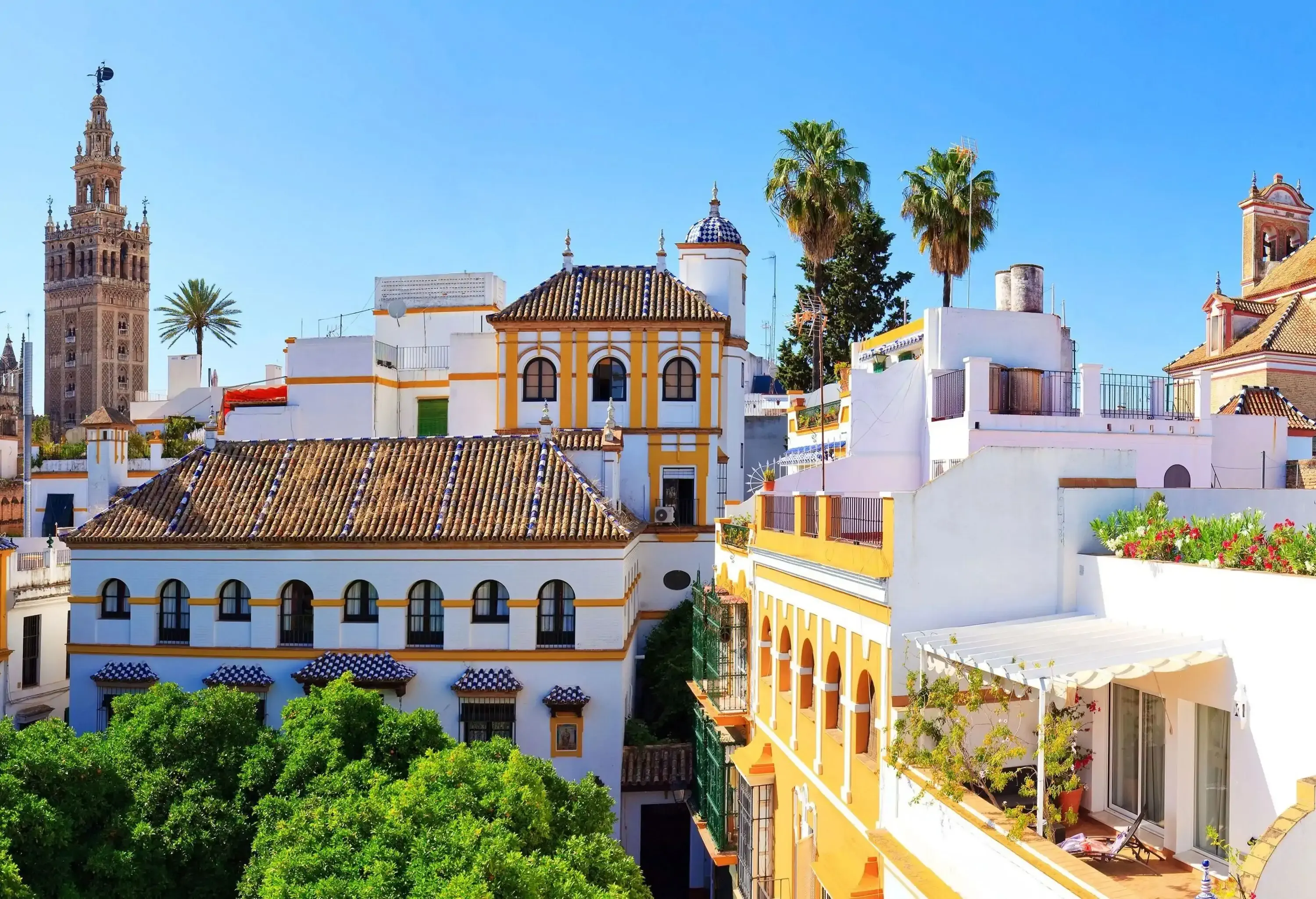 A colourful skyline with ornate buildings and towers jutting into the clear blue sky.