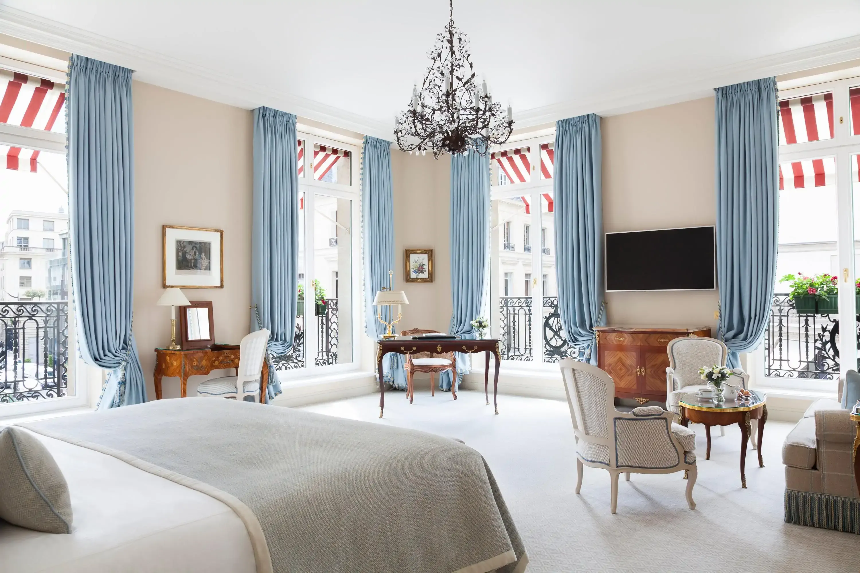 Hotel room with white carpet in a classic French style with four windows