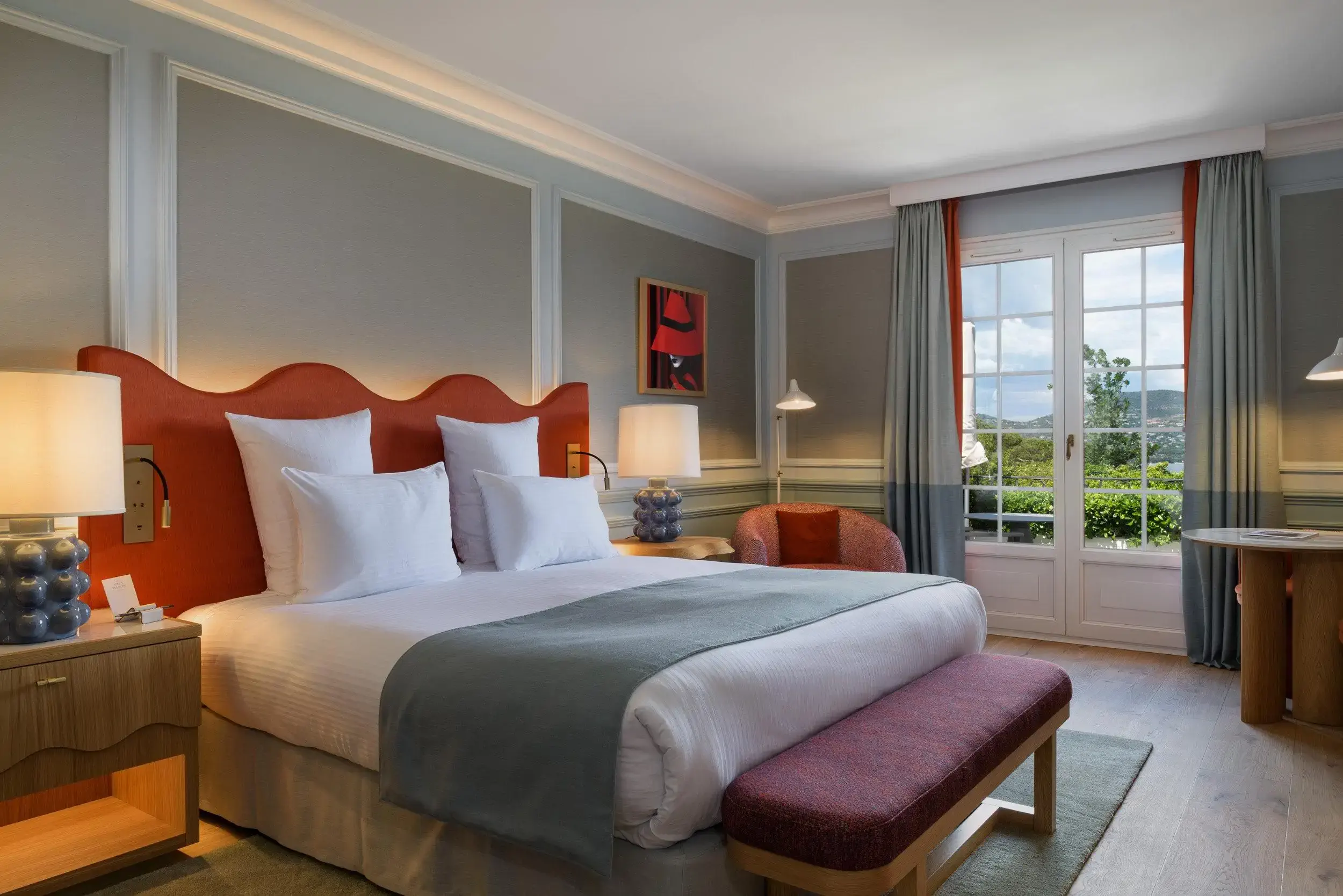 Hotel room with wood panelling and view over a bay