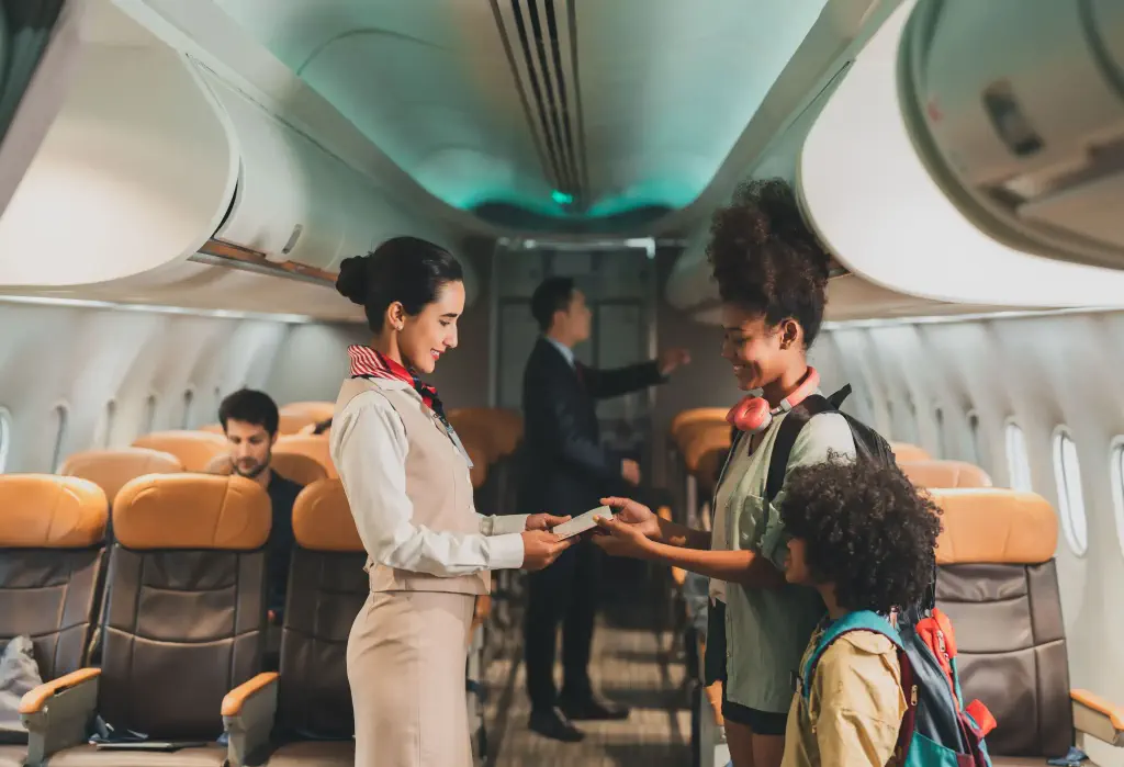 Lifestyle of tourists traveling on a plane.Air steward takes care of passengers on the plane.Adult passengers traveling on economy class aircraft