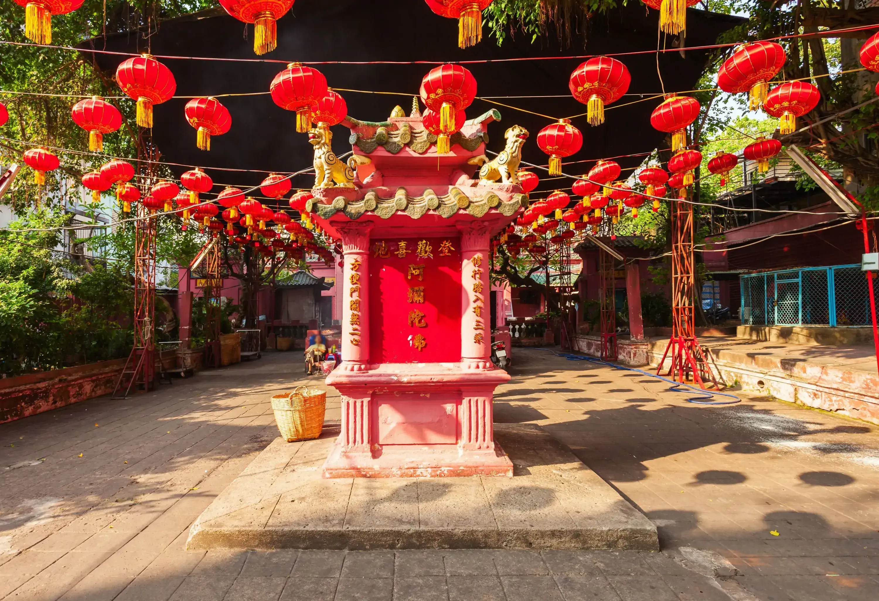 Red spherical paper lanterns hanging over the entryway of a Taoist temple.