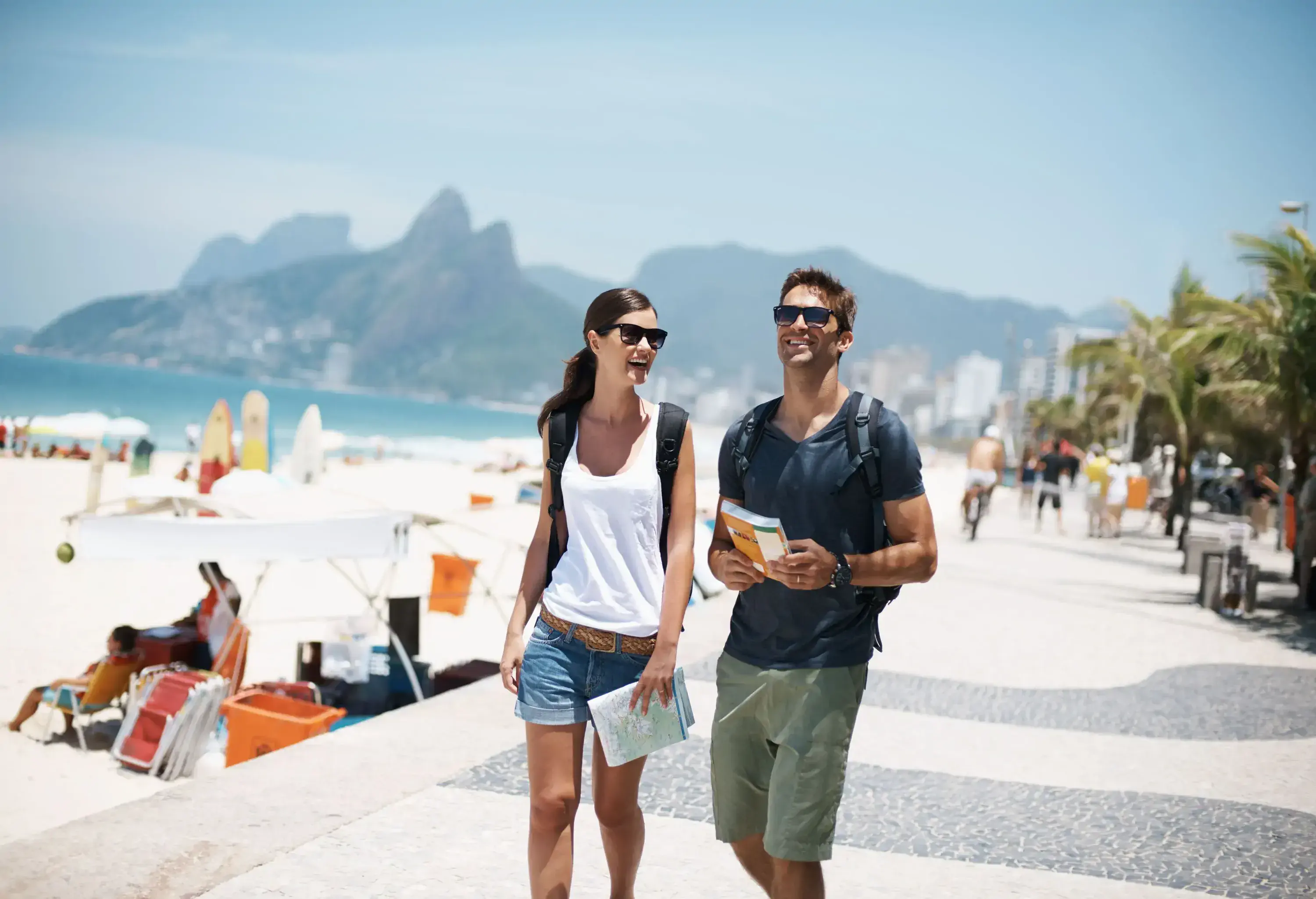Cropped shot of a young couple walking beside the beach