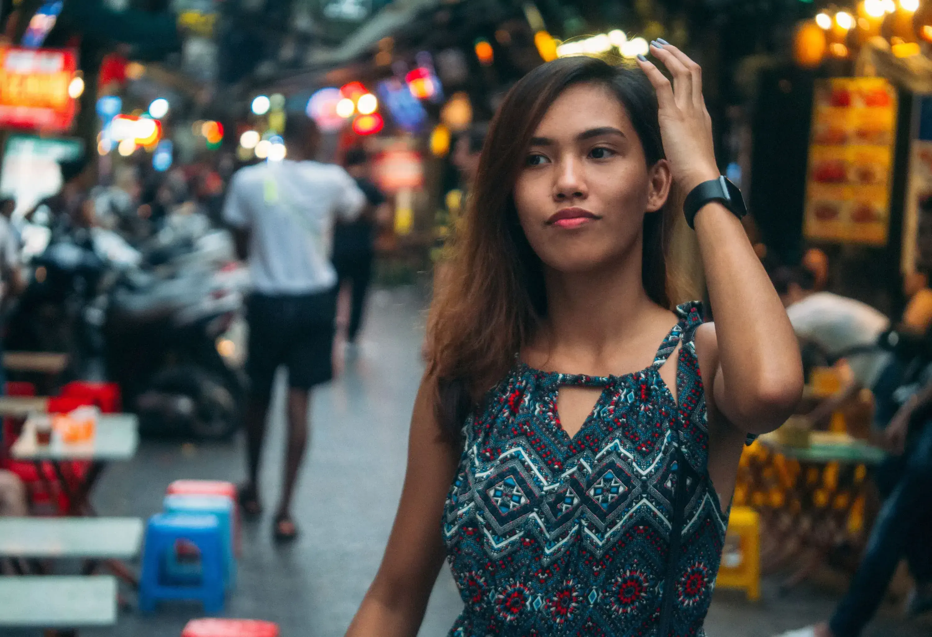 A young woman strolling through a market street.