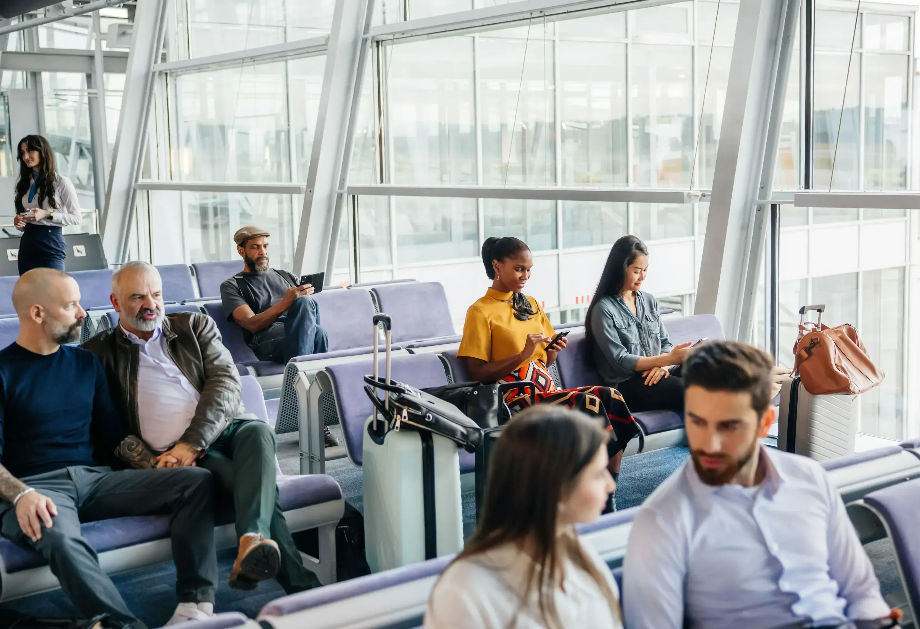 People waiting by the gate at the airport